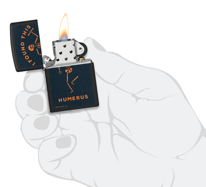 Zippo Buck Wear™ Humerus Design Black Matte Windproof Lighter lit in hand.