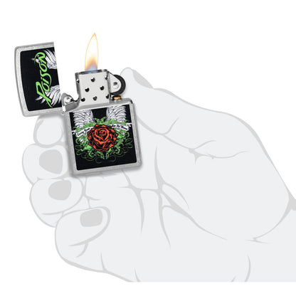 Zippo Poison Winged Rose Design Street Chrome Windproof Lighter lit in hand.