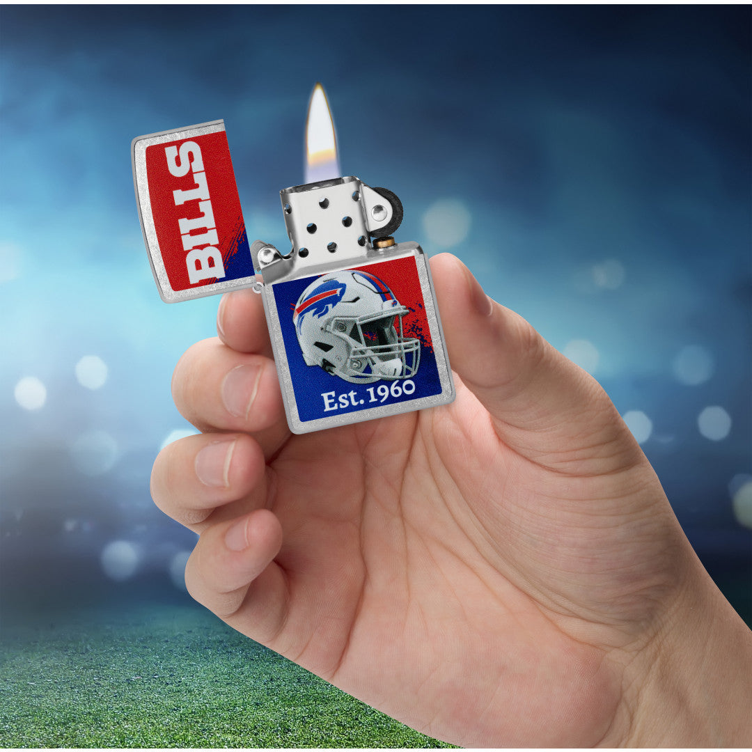 Zippo NFL Buffalo Bills Helmet Design Street Chrome Windproof Lighter lit in hand.