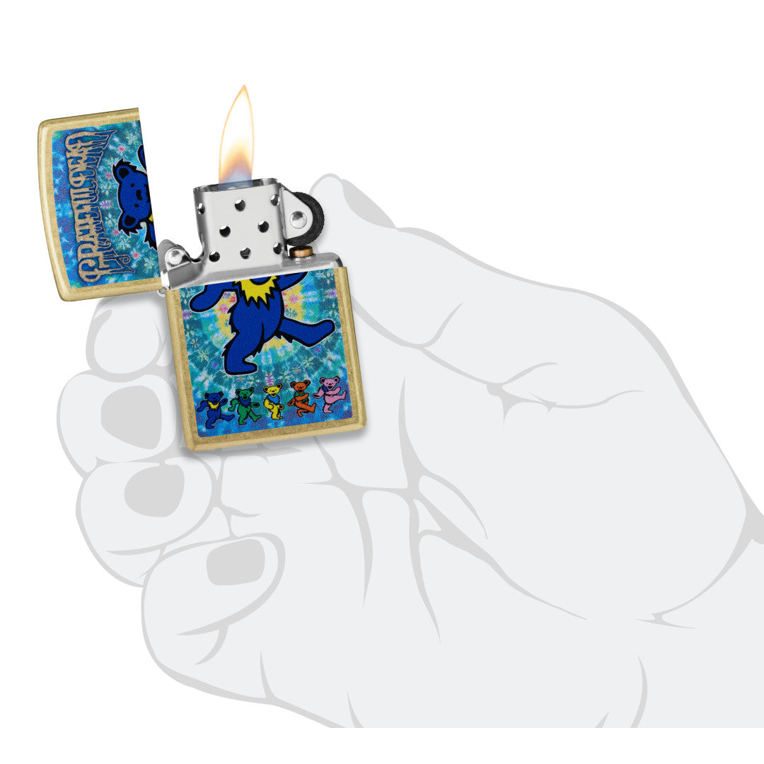 Zippo Grateful Dead Dancing Bears Design Street Brass Windproof Lighter lit in hand.