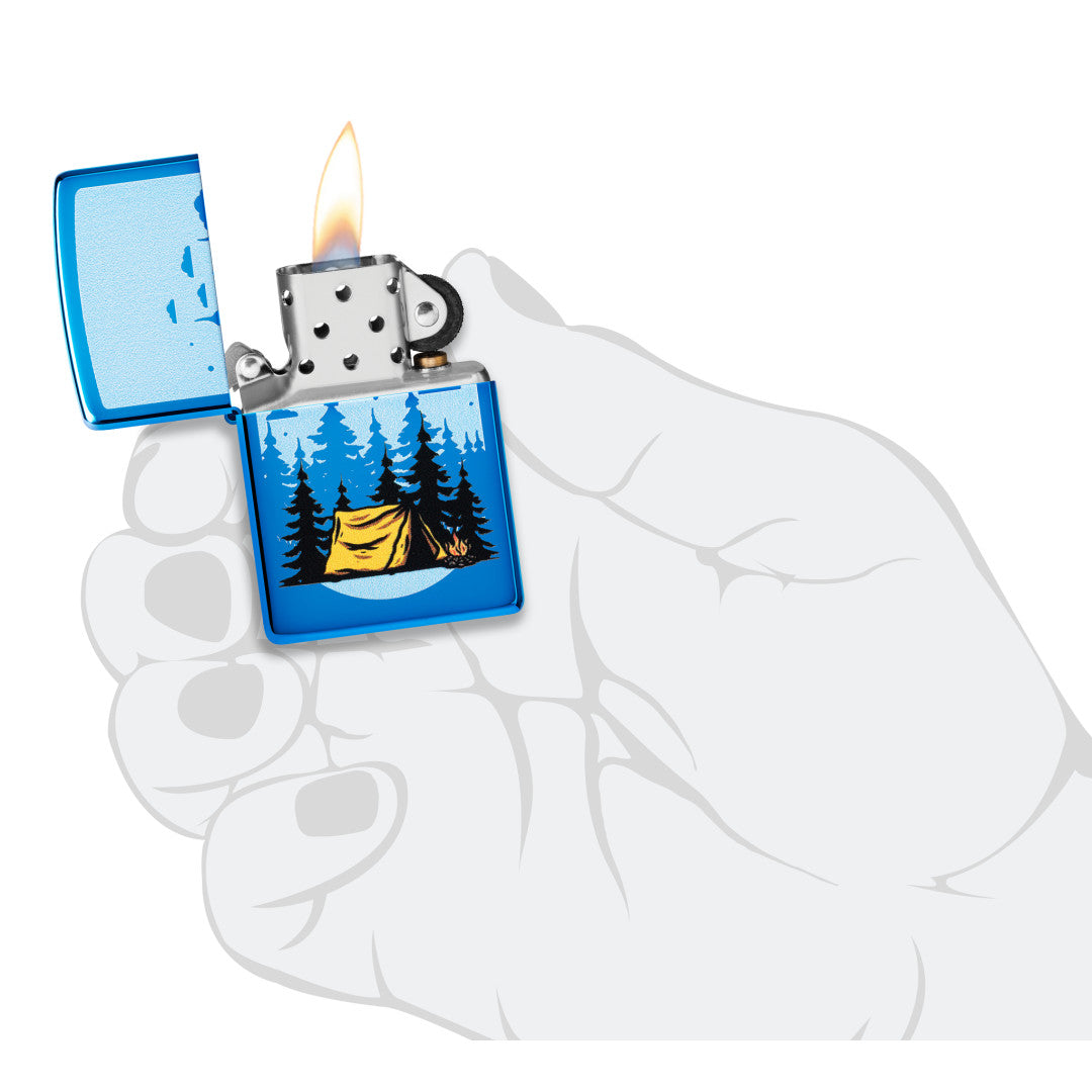 Zippo Forest Flicker Design High Polish Blue Windproof Lighter lit in hand.