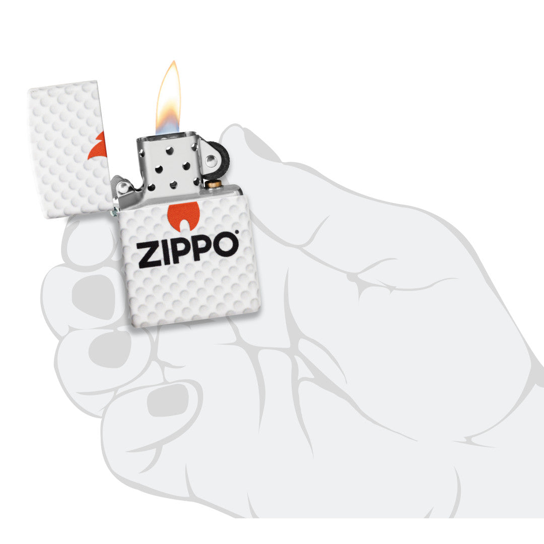 Zippo Golf Ball Design 540 Matte Windproof Lighter lit in hand.