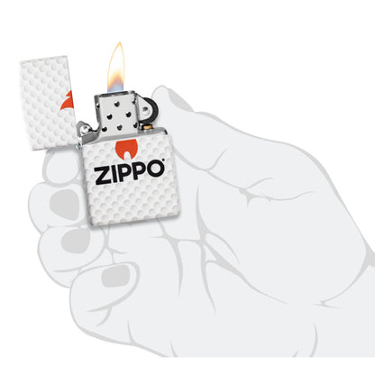 Zippo Golf Ball Design 540 Matte Windproof Lighter lit in hand.