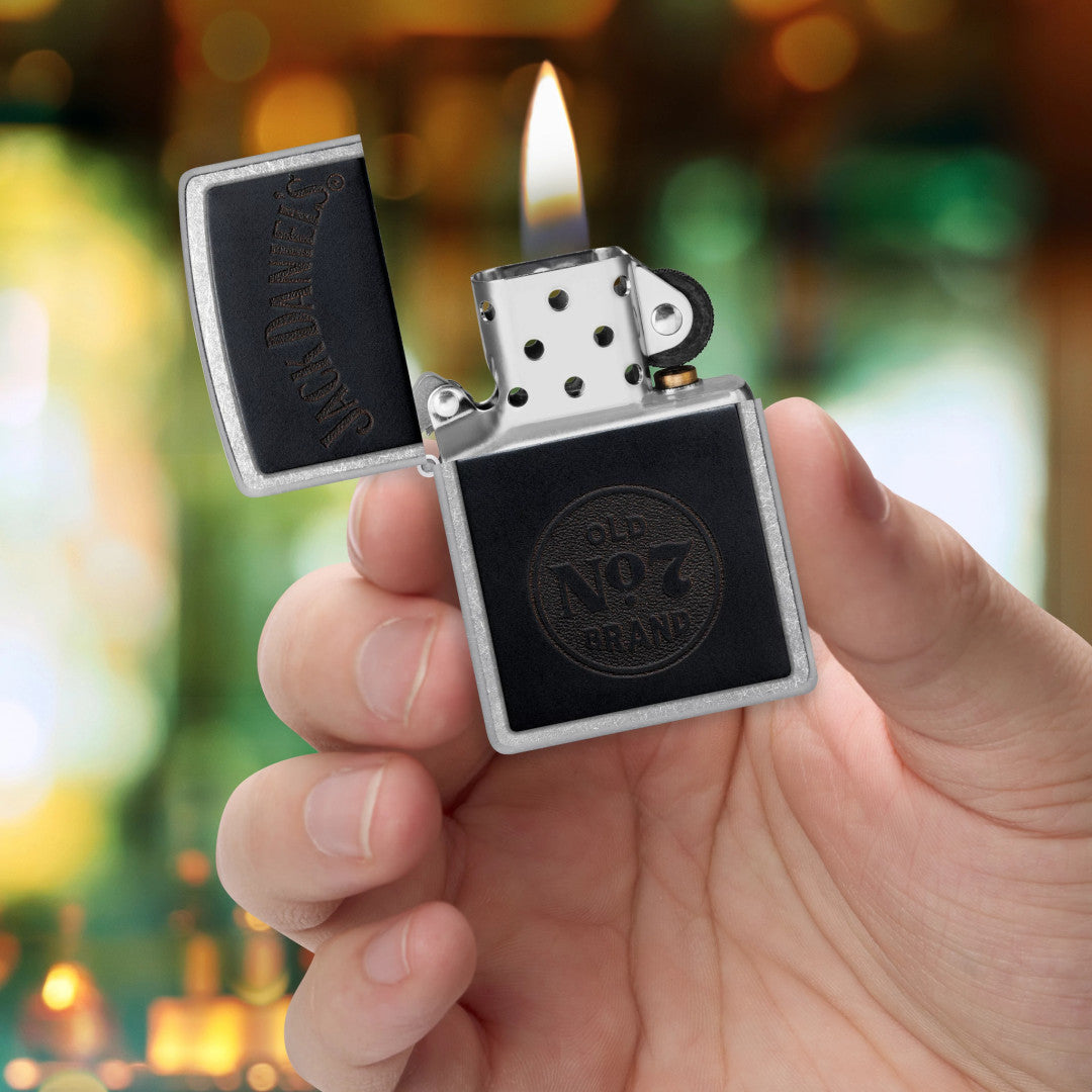 Zippo Jack Daniel's Old No. 7 Leather Emblem Street Chrome Windproof Lighter lit in hand.