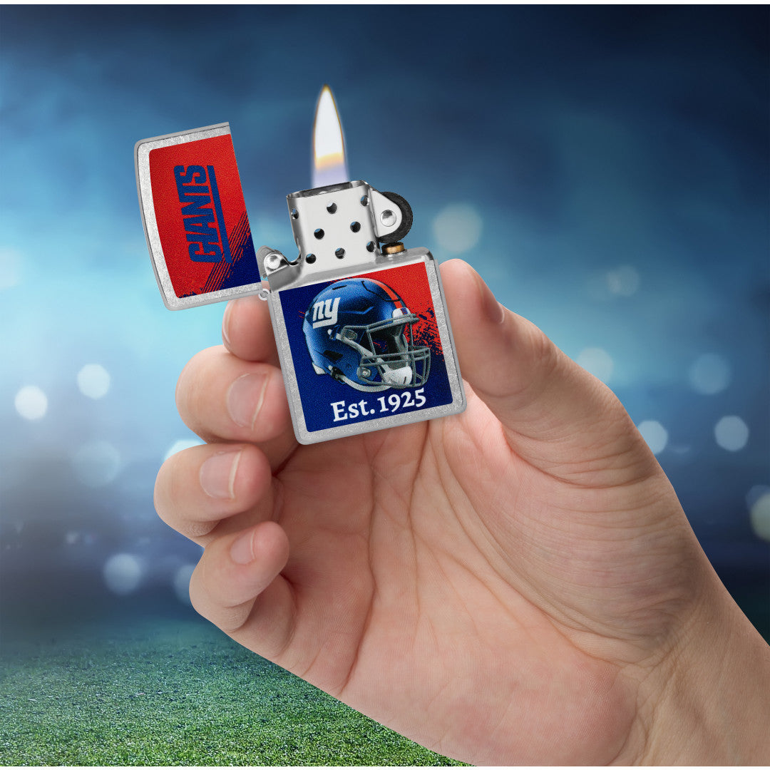 Zippo NFL New York Giants Helmet Design Street Chrome Windproof Lighter lit in hand.