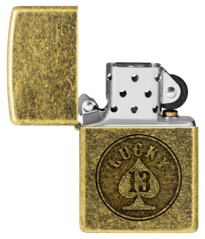 Zippo Lucky 13 Design Antique Brass Windproof Lighter with its lid open and unlit.