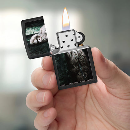Zippo Squatch Cam Design Black Matte Windproof Lighter lit in hand.