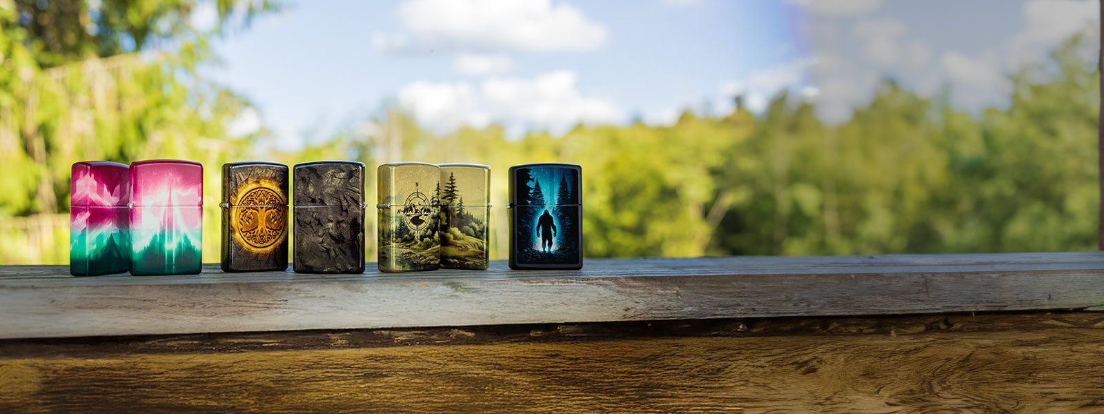 Colorful lighters with color image designs on a wooden surface with a natural background