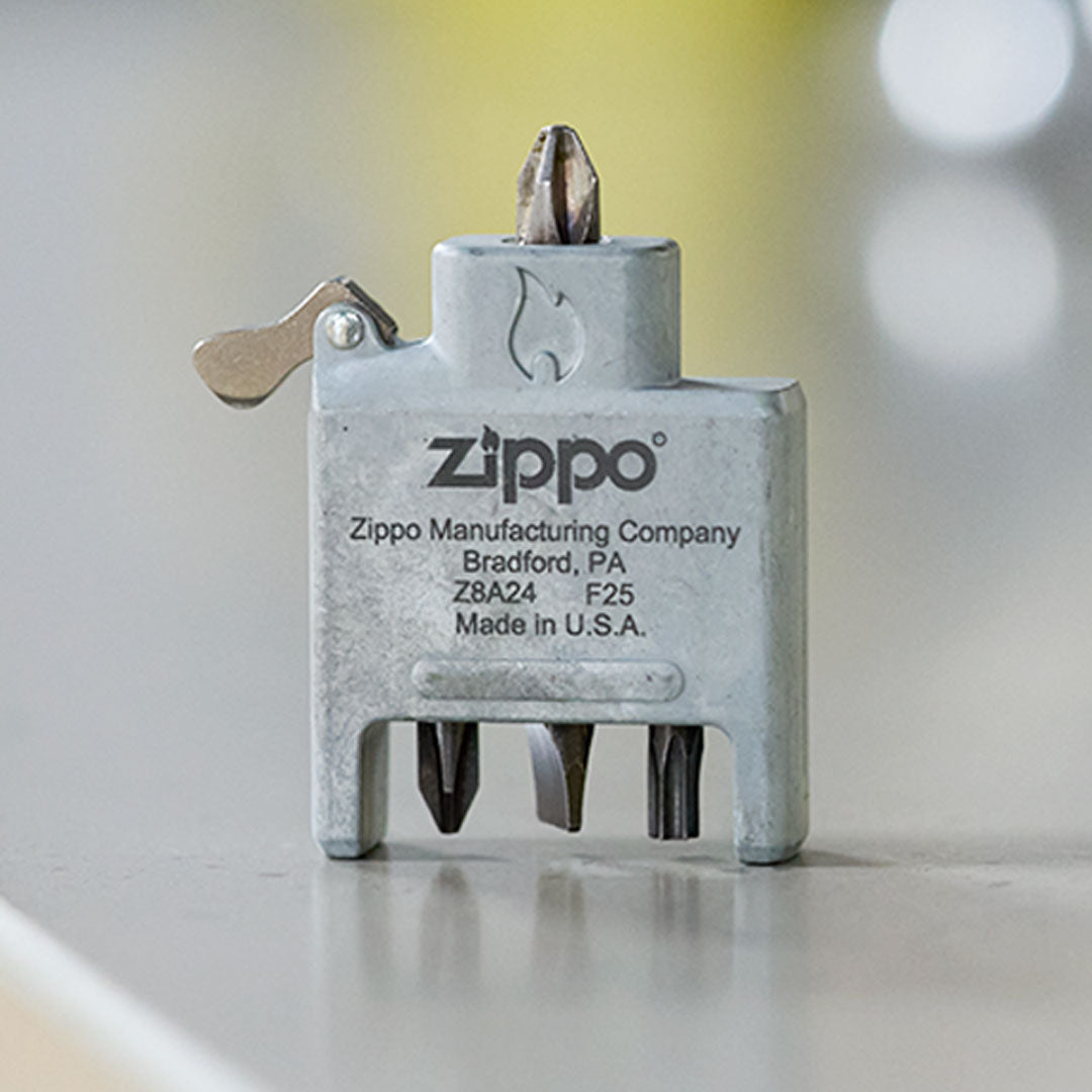 Zippo Bit Safe Screwdriver Insert on a reflective surface with a blurred background