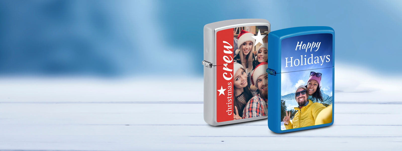 Two personalized zippo lighters with festive designs on a white surface.