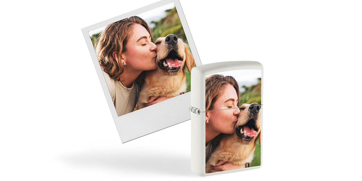 A white rectangular lighter with a custom printed photo of a woman kissing a dog, shown next to a matching Polaroid-style photo print on a clean white background.