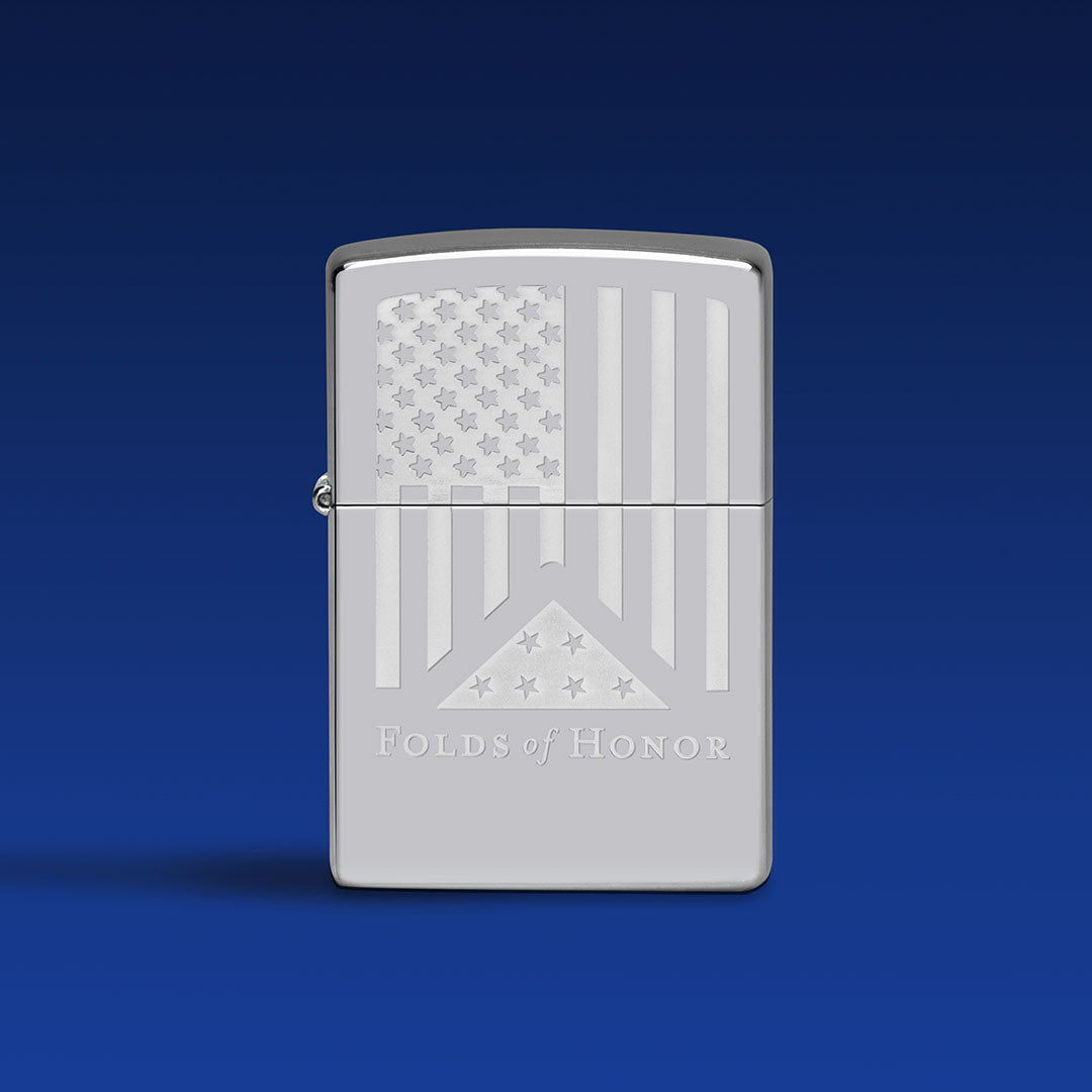 Silver Zippo lighter with 'Folds of Honor' design on a blue background