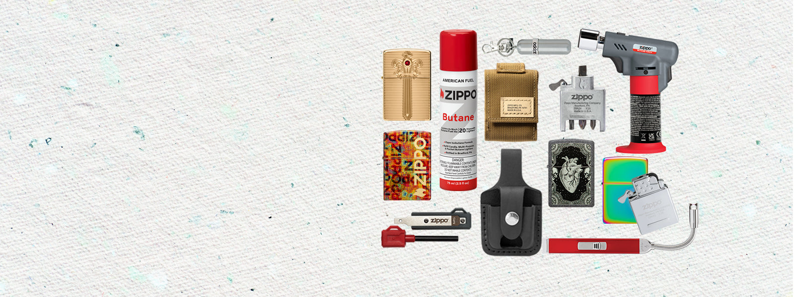 Collection of various items including a Zippo lighter, spray can, and other small objects on a textured white background.