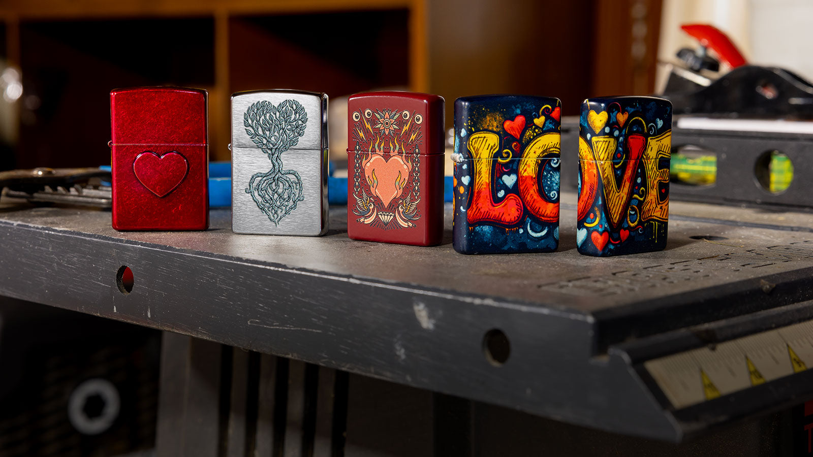 Four different lighters with Love themed designs.