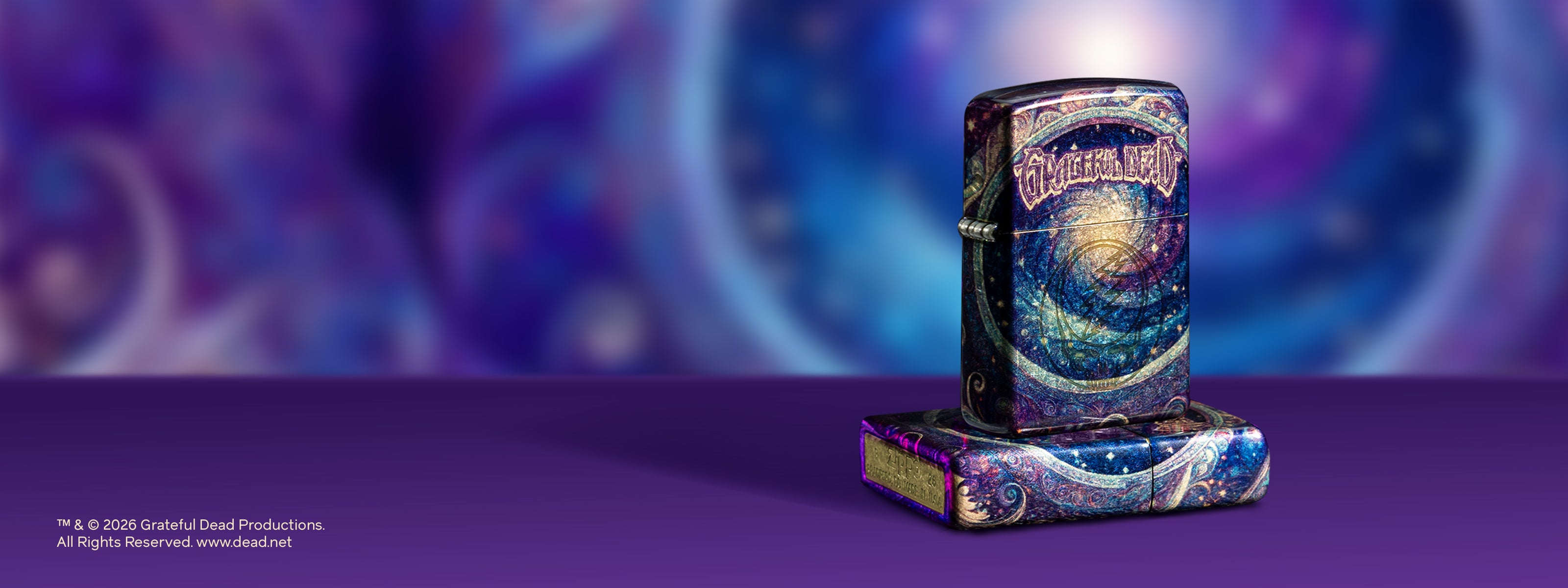 Two 2026 purple and blue Grateful Dead Zippo lighters in front of a purple background.