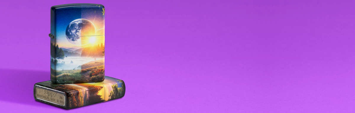 Two of the same SMS Exclusive lighters photographed against a solid purple background.