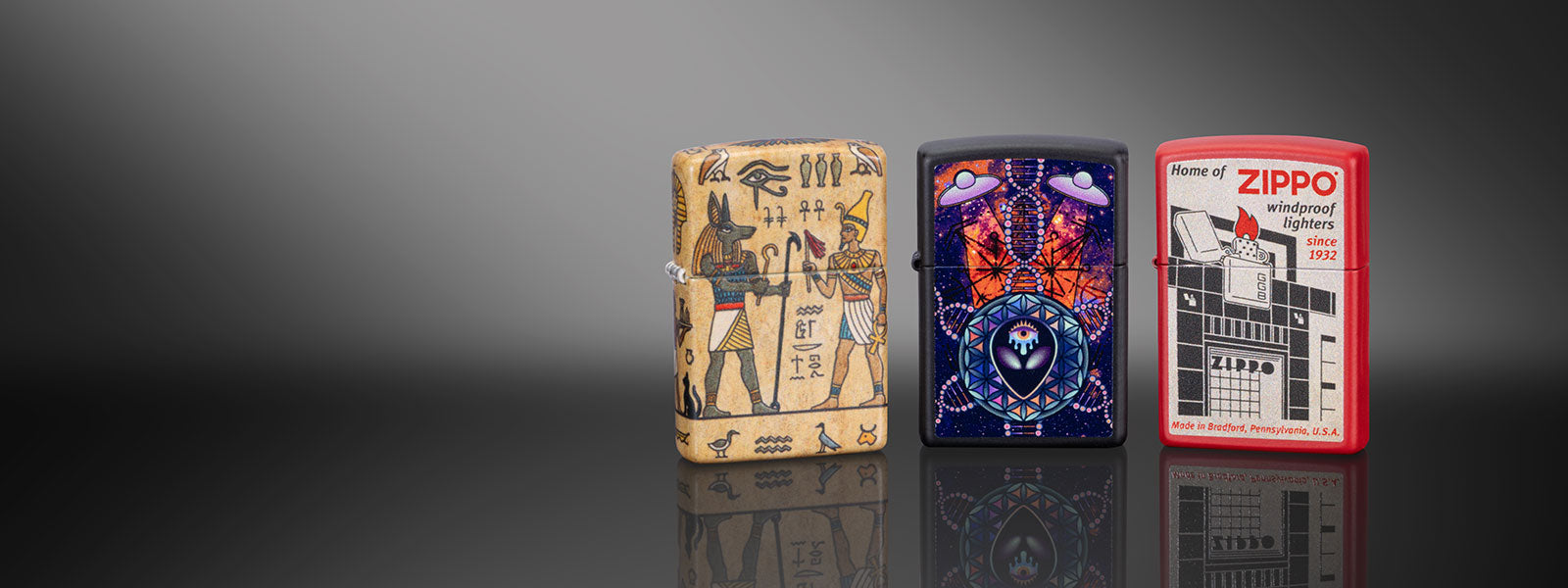 Three Zippo lighters with different designs on a reflective surface.