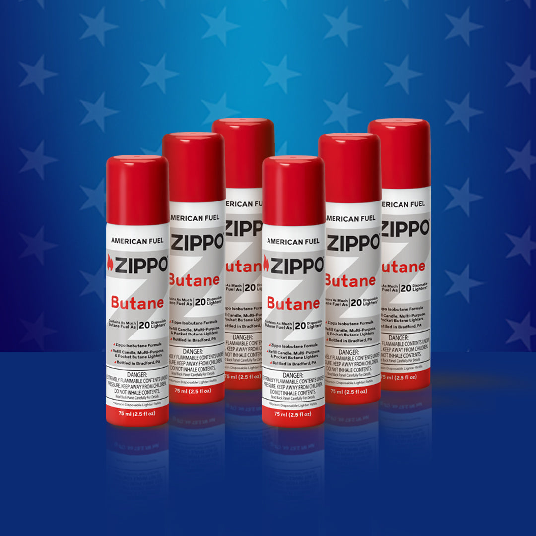 Six Zippo butane cans on a blue background.