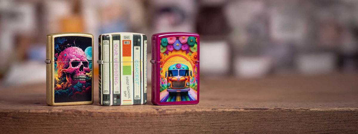 One skull Zippo lighter, one old-school styled lighter, and one pink one with flowers and a bus on the front.