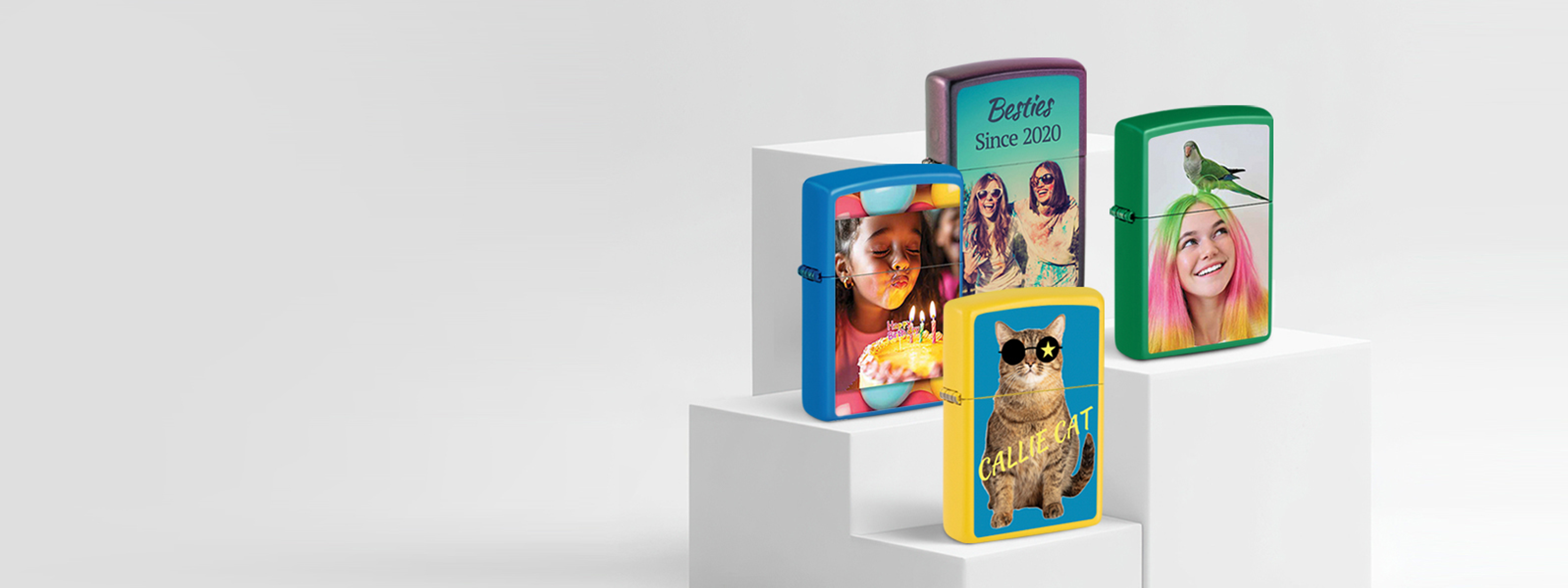 Four personalized Zippo lighters with colorful designs on a white background.
