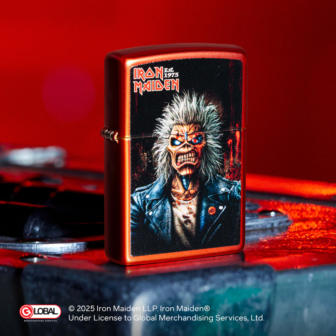 Zippo lighter with Iron Maiden design on a red background
