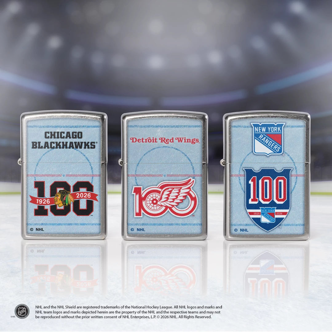 Three Zippo lighters with NHL team logos and '100' celebrations on a reflective surface.
