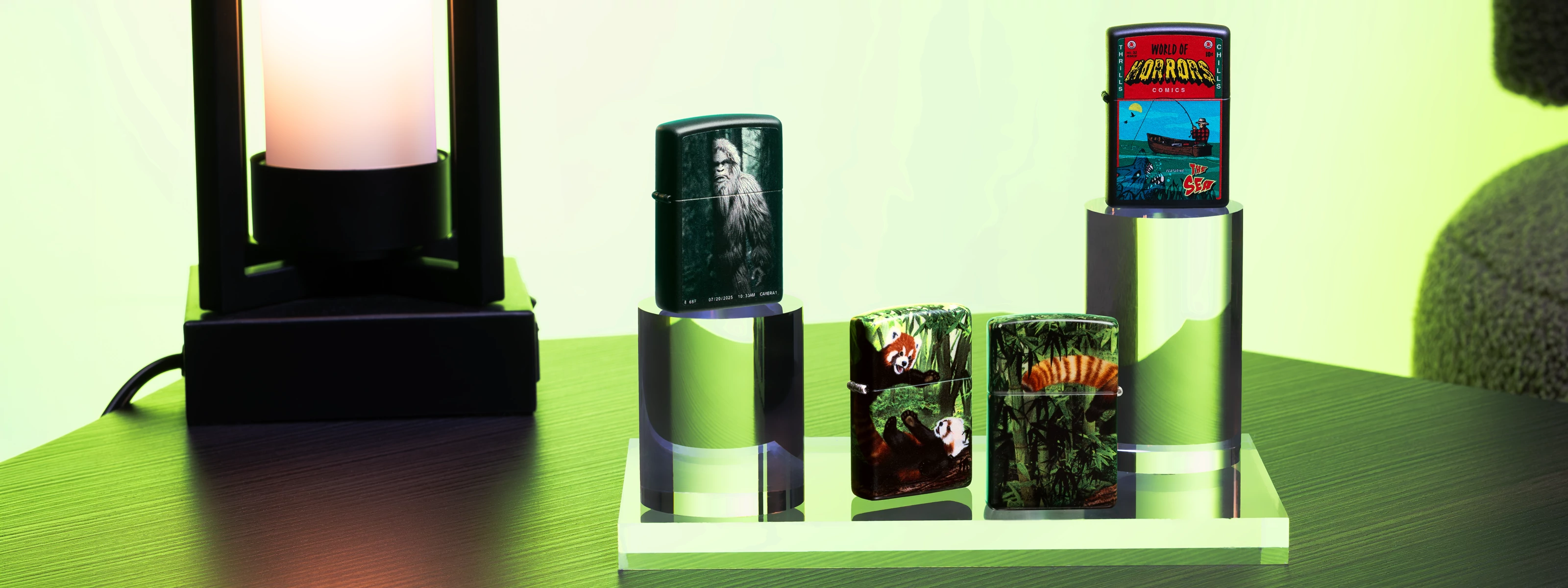 4 Zippo August Web Debut lighters in front of a green background.