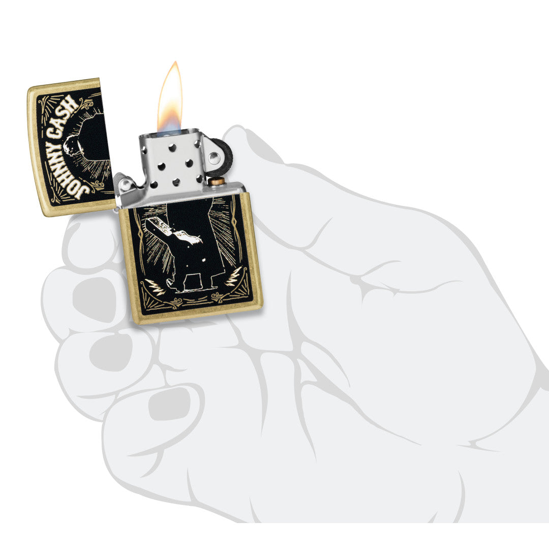 Zippo Johnny Cash Walk Design Street Brass Windproof Lighter lit in hand.