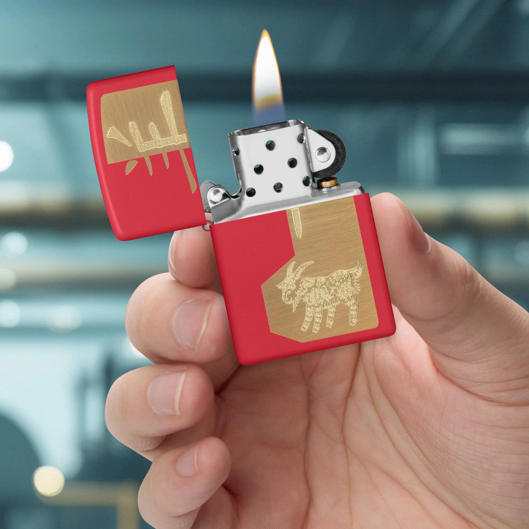 Zippo 2027 Year of the Sheep Design Red Matte Windproof Lighter lit in hand.