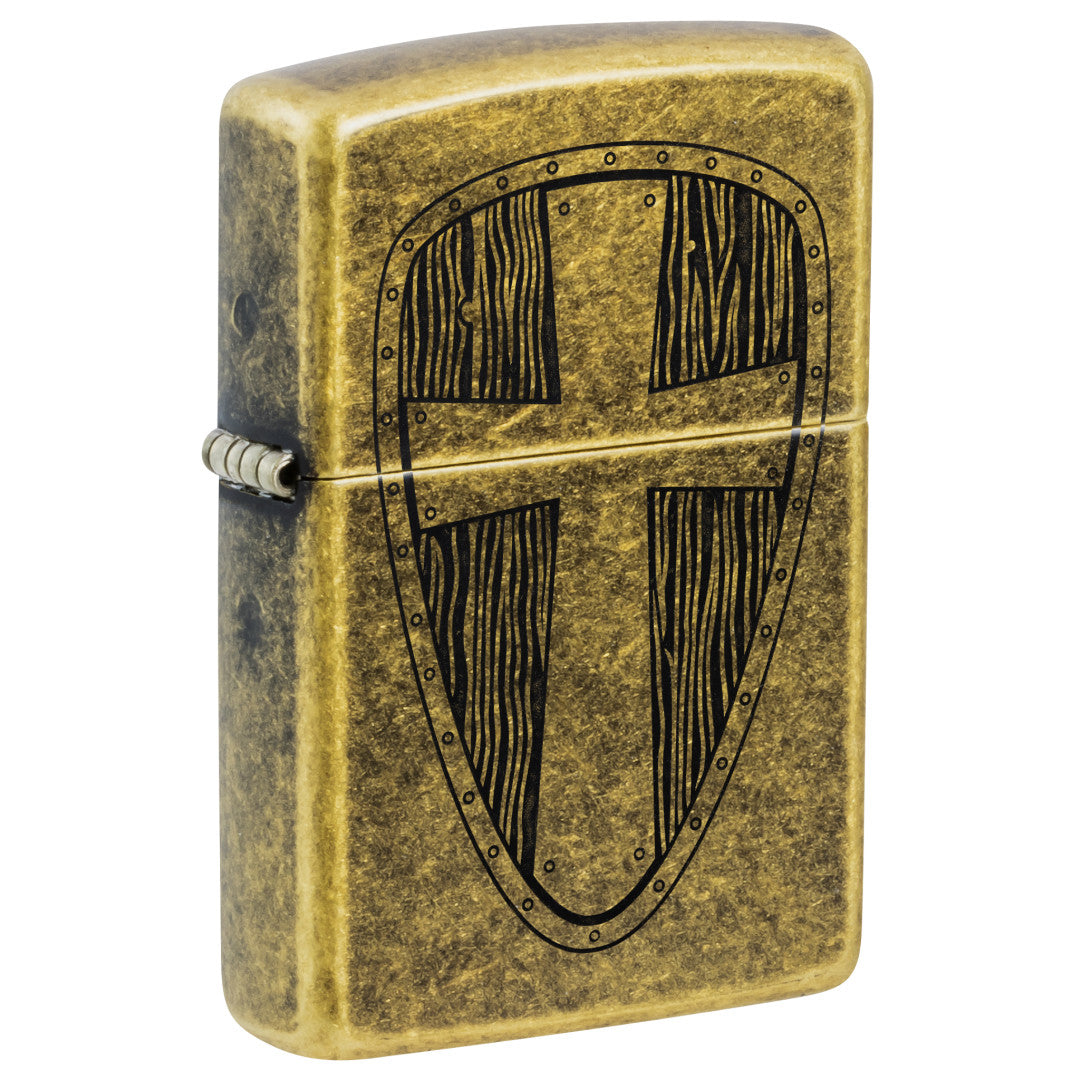 Front shot of Zippo Medieval Shield Design Antique Brass Windproof Lighter standing at a 3/4 angle.