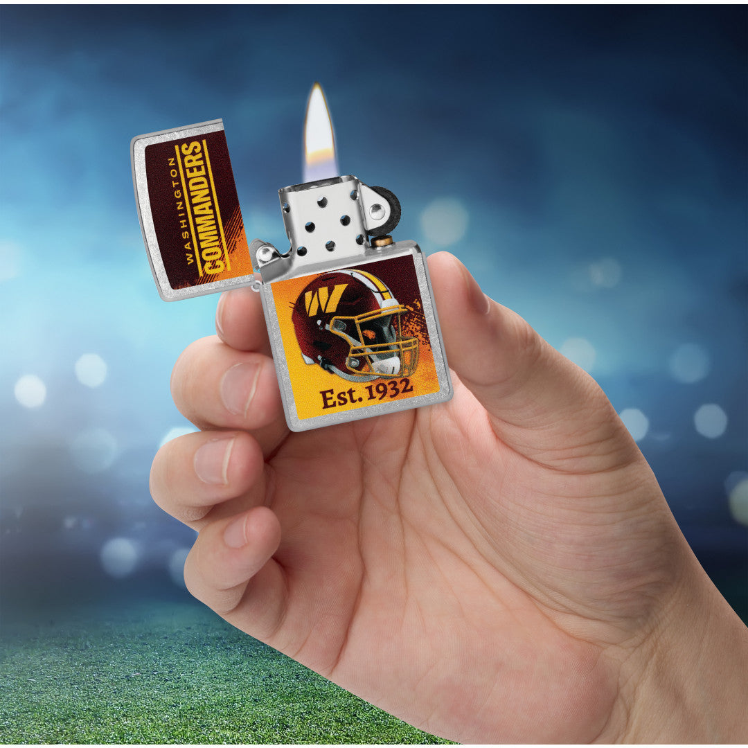Zippo NFL Washington Commanders Helmet Design Street Chrome Windproof Lighter lit in hand.