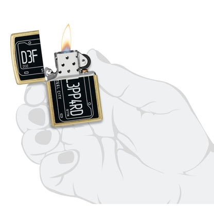 Zippo Def Leppard Steel City Design Street Brass Windproof Lighter lit in hand.