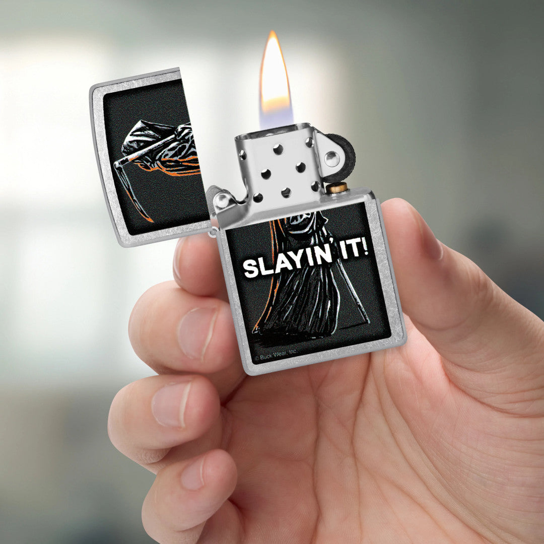 Zippo Buck Wear™ Slayin' It Design Street Chrome Windproof Lighter lit in hand.