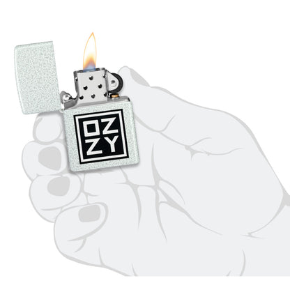 Zippo Ozzy Osbourne Block Design Glacier Windproof Lighter lit in hand.