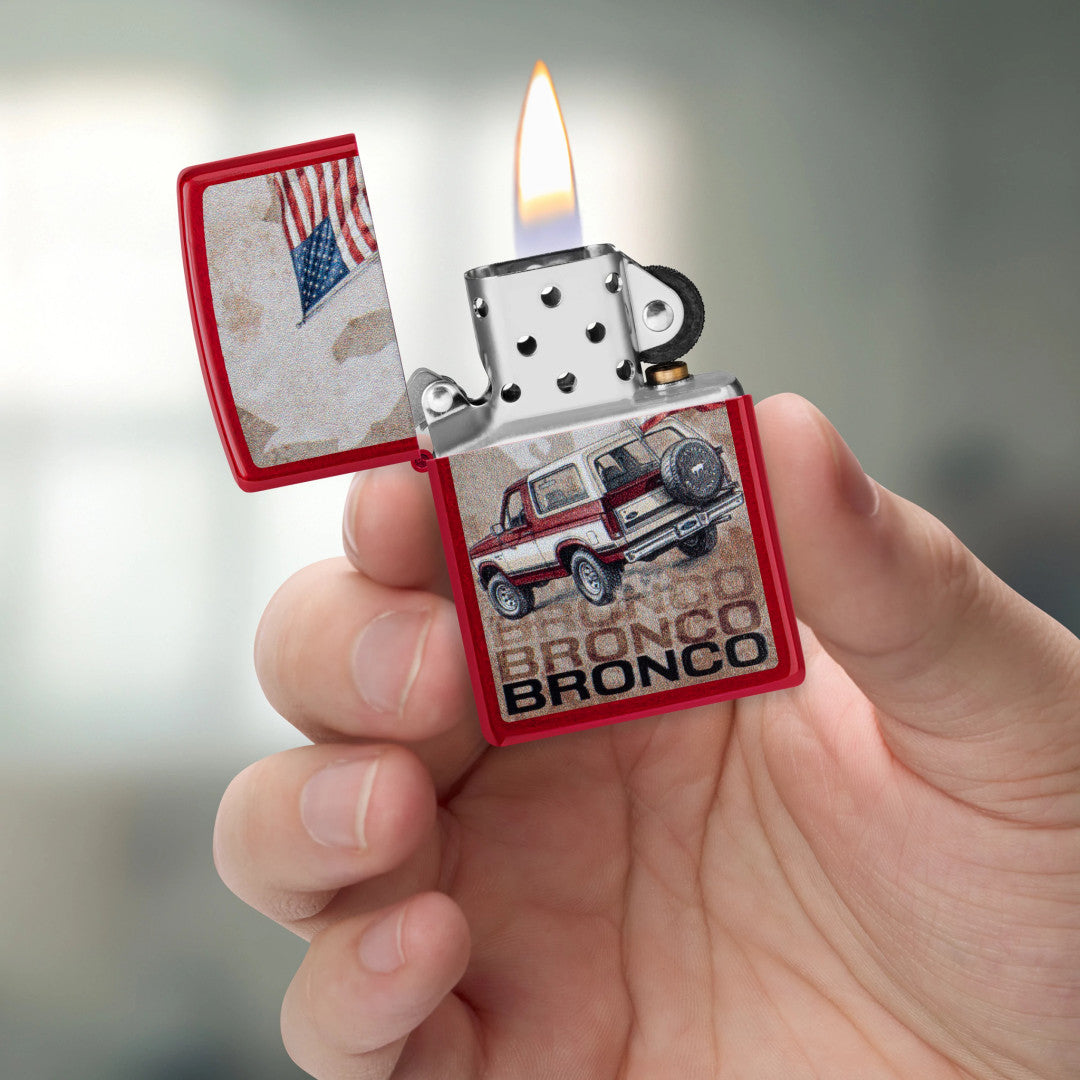 Zippo Ford Bronco Flag Design Candy Apple Red Windproof Lighter lit in hand.