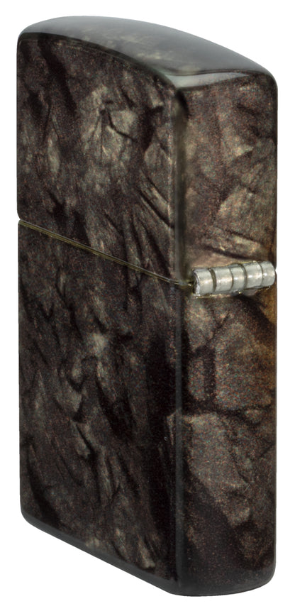 Angled shot of  Zippo Gleaming Tree of Life Design 540 Tumbled Brass Windproof Lighter showing the back and hinge sides of the lighter.