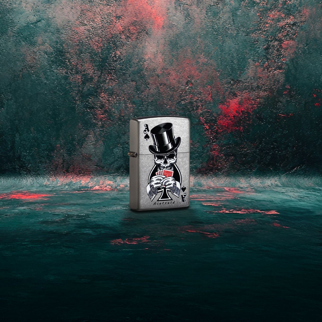 Lifestyle image of Zippo Rietveld Ace of Spades Design Street Chrome Windproof Lighter standing at a 3/4 angle showing the front and hinge side of the lighter with a dark gray and red graffiti background.

