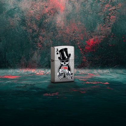 Lifestyle image of Zippo Rietveld Ace of Spades Design Street Chrome Windproof Lighter standing at a 3/4 angle showing the front and hinge side of the lighter with a dark gray and red graffiti background.

