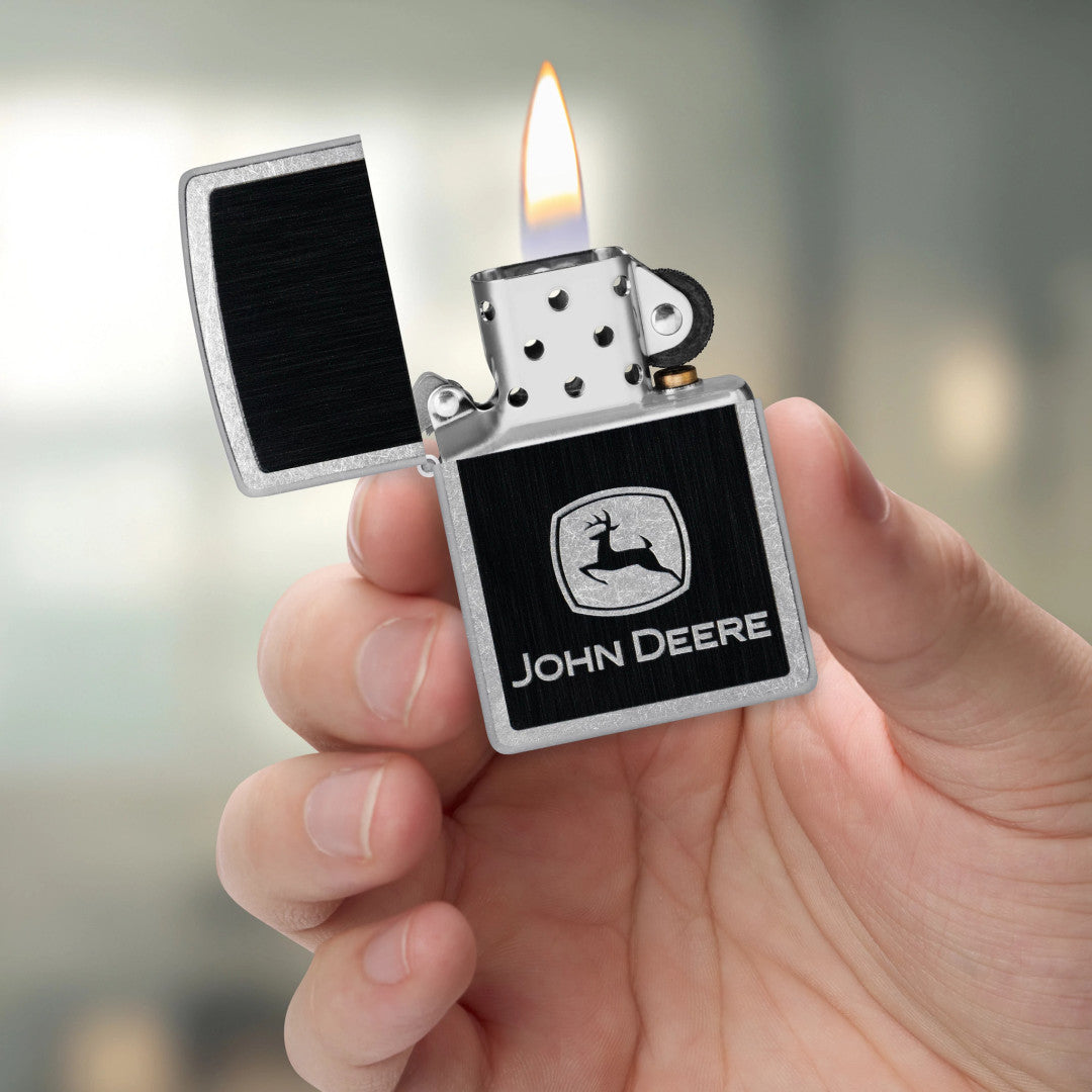 Zippo John Deere Chrome Logo Design Street Chrome Windproof Lighter lit in hand.