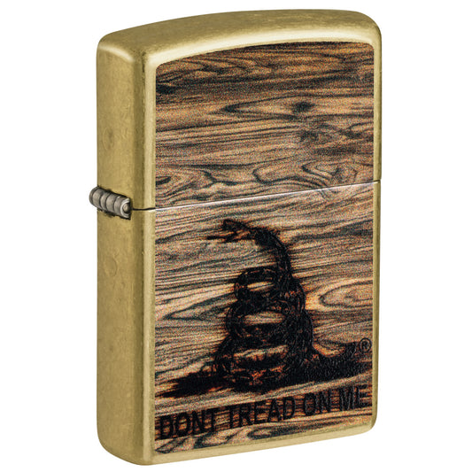 Front shot of Zippo Don't Tread On Me® Woodburn Design Street Brass Windproof Lighter standing at a 3/4 angle.