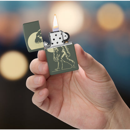 Zippo Sasquatch Stroll Design Green Matte Windproof Lighter lit in hand.