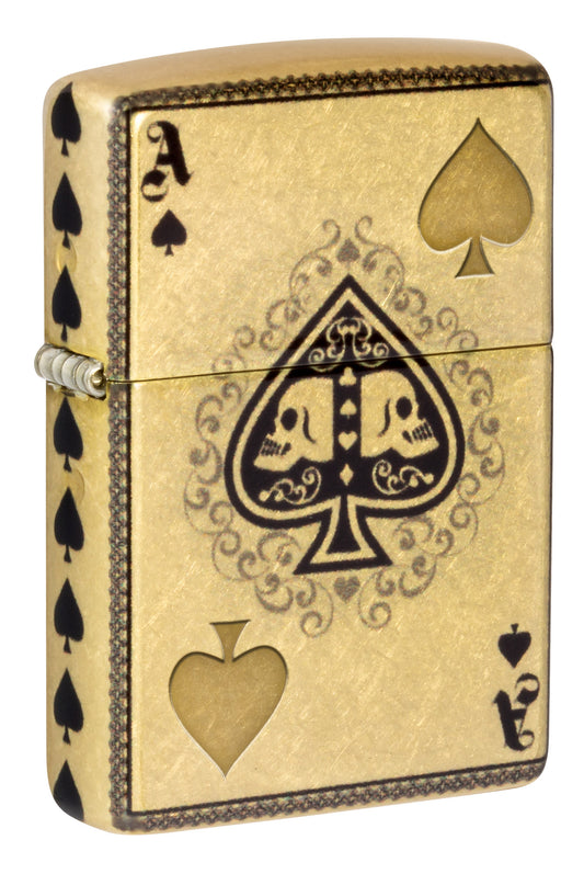 Front shot of Zippo Ace of Skulls Design 540 Tumbled Brass Windproof Lighter standing at a 3/4 angle.