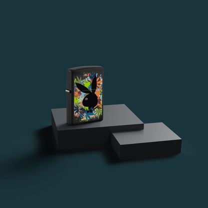 Lifestyle image of Zippo Playboy Rabbit Head Silhouette Black Matte Windproof Lighter standing on a black two-tier display with a dark teal background.