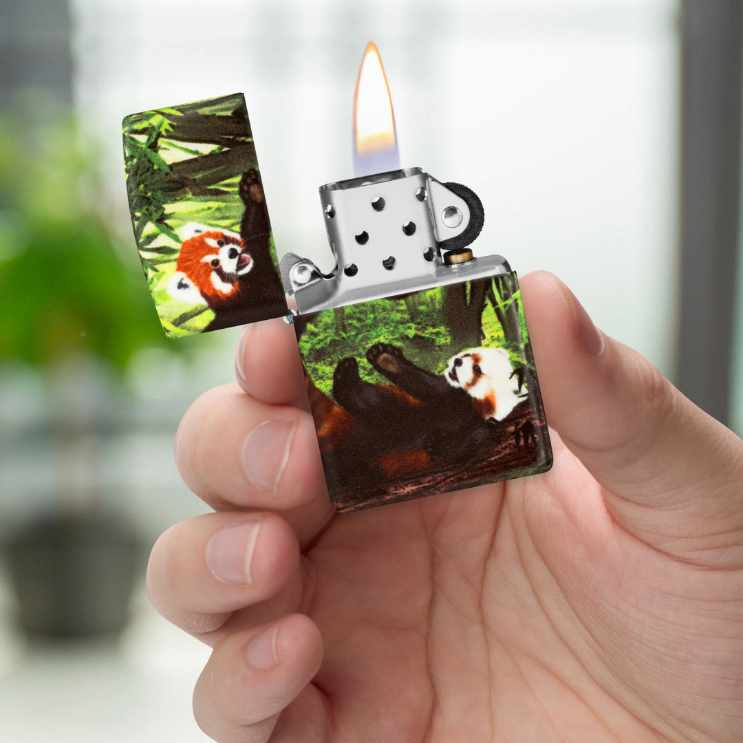 Zippo Panda Party Design 540 matte Windproof Lighter lit in hand.
