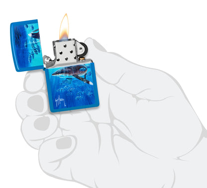 Zippo Guy Harvey Co-Pilot Design Sky Blue Matte Windproof Lighter lit in hand.