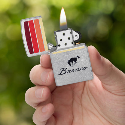 Zippo Ford Bronco Sunset Stripes Design Street Chrome Windproof Lighter lit in hand.
