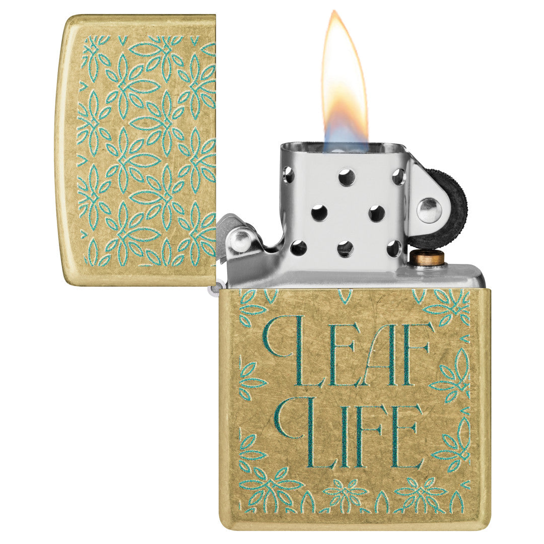 Zippo Leaf Life Design Street Brass Windproof Lighter with its lid open and lit.