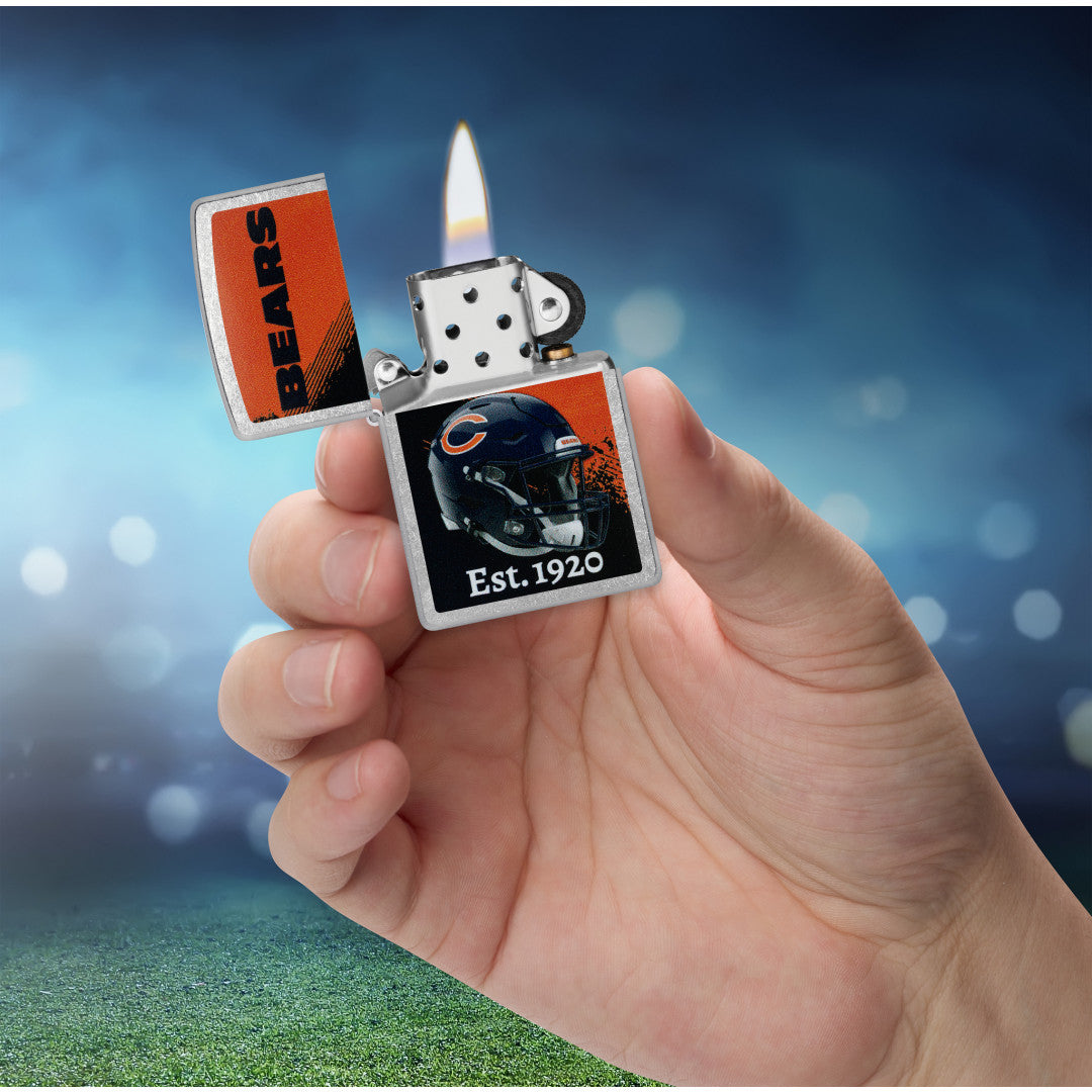Zippo NFL Chicago Bears Helmet Design Street Chrome Windproof Lighter lit in hand.