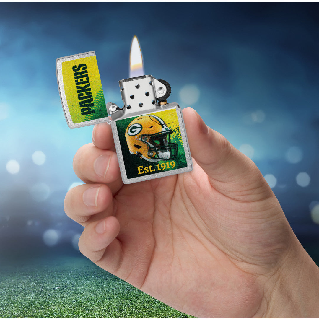 Zippo NFL Green Bay Packers Helmet Design Street Chrome Windproof Lighter lit in hand.