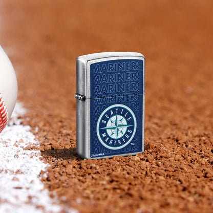 Lifestyle image of Zippo MLB® Seattle Mariners Street Chrome Windproof Lighter standing in the dirt on a baseball field.